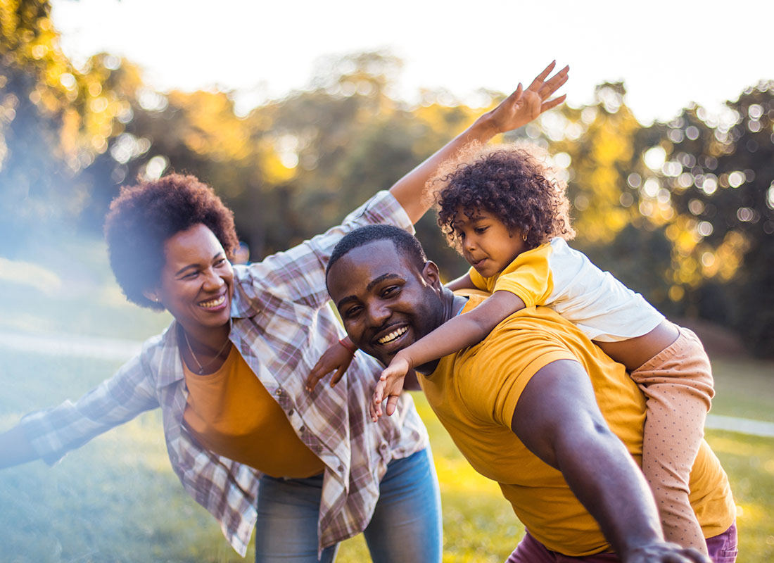 Read Our Reviews - Closeup Portrait of a Cheerful Family Having Fun Playing Outside on a Sunny Day in the Park